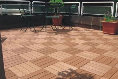 Interlocking wooden tiles on a terrace with chairs and potted plants