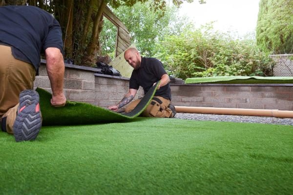 Men Laying Artificial Grass on Floor