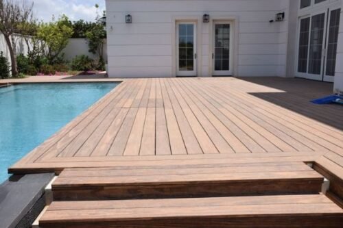 Wooden deck beside a modern swimming pool