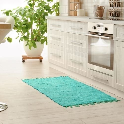 Turquoise fringed mat in kitchen